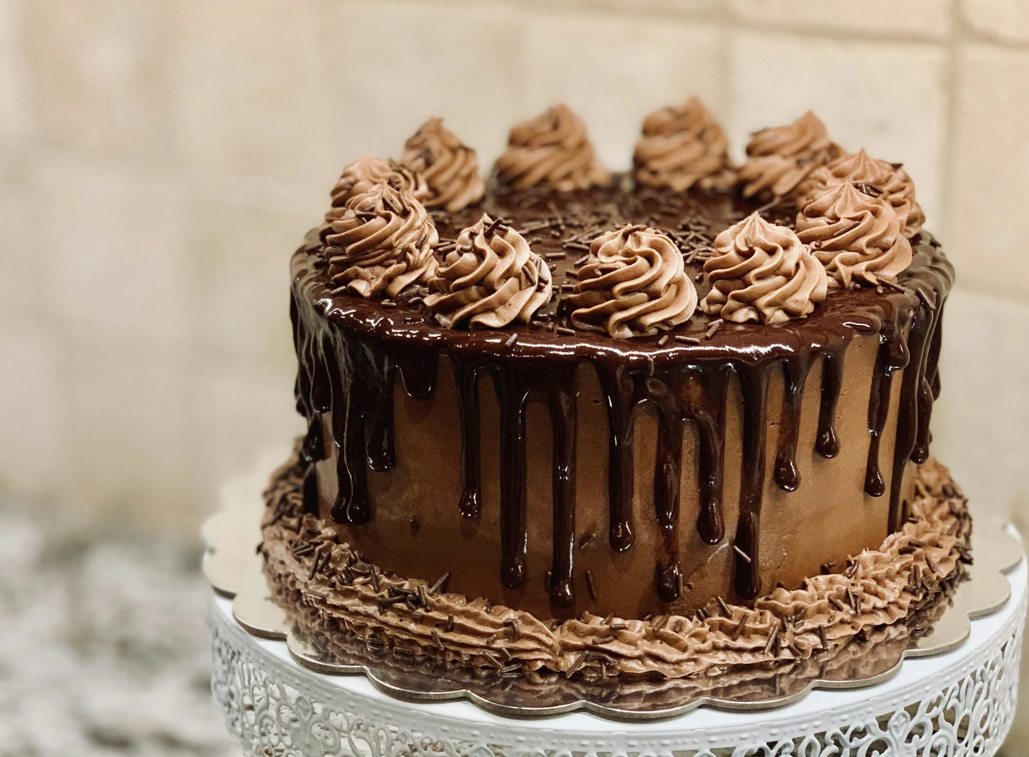 Chocolate drip cake on a stand