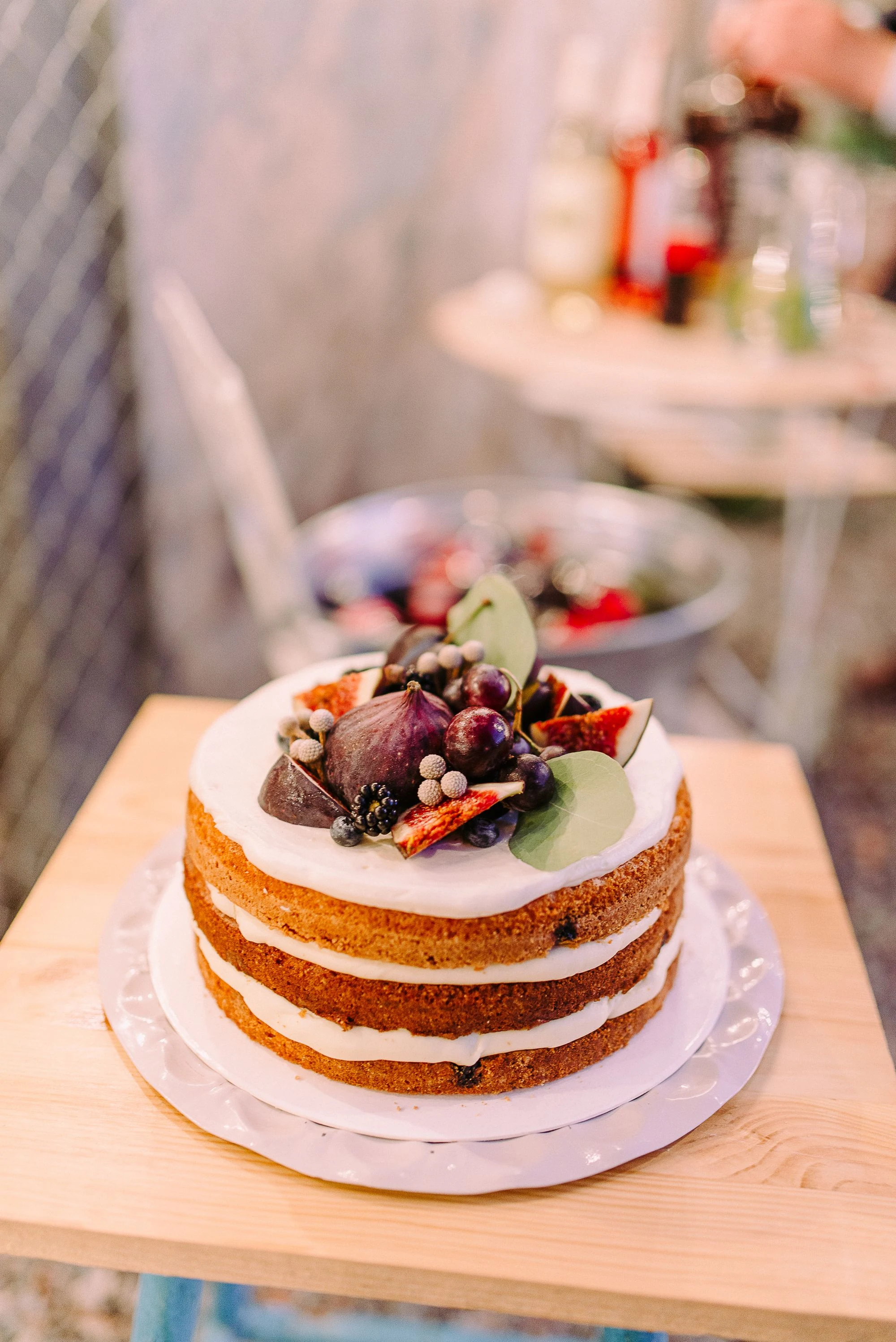 Naked vanilla cake with figs and berries